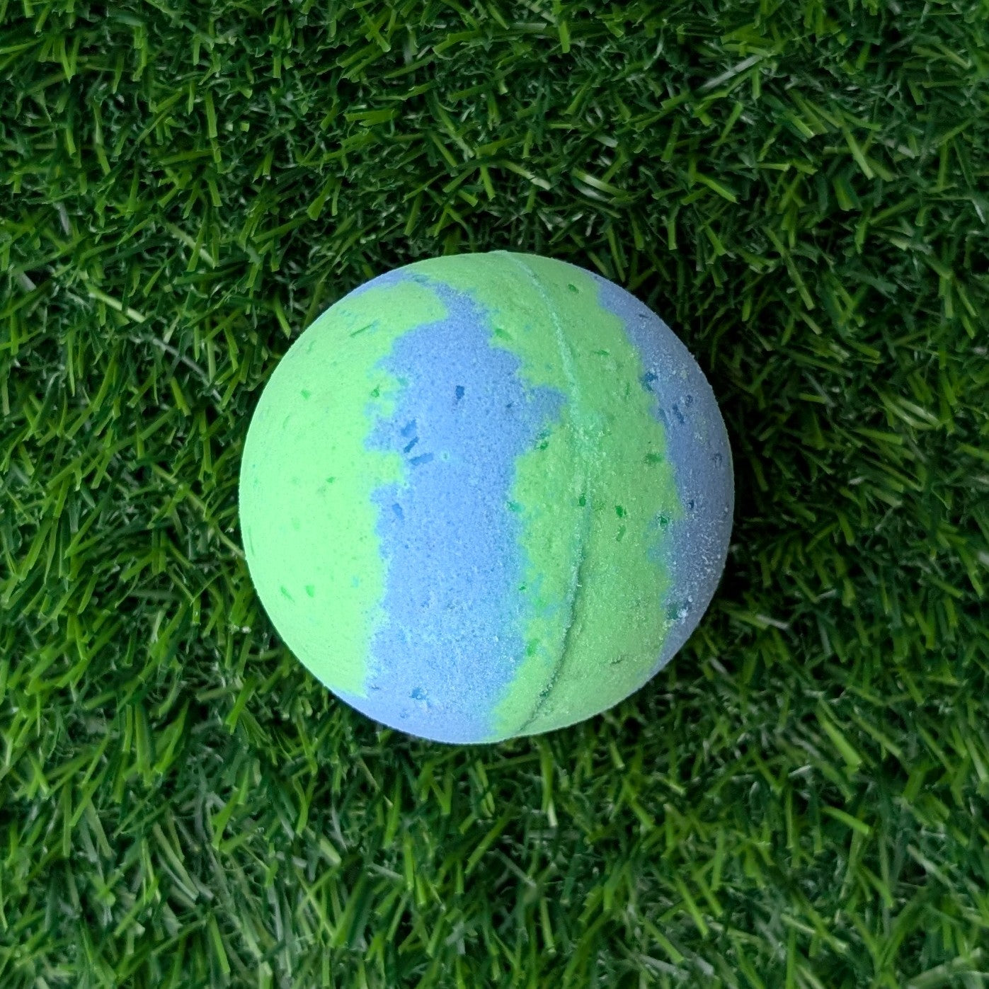 Green and blue bath bomb on grass