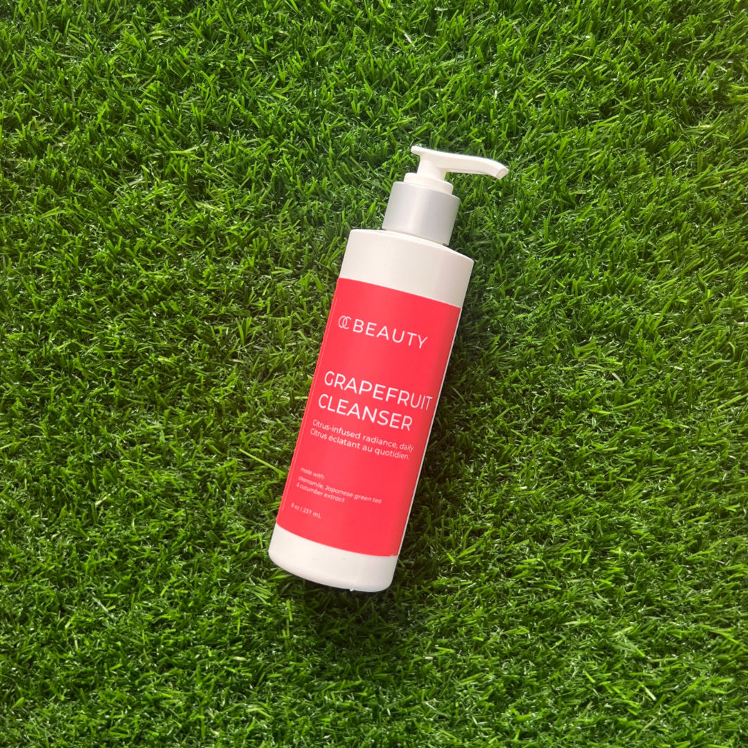 Grapefruit cleanser bottle on green grass