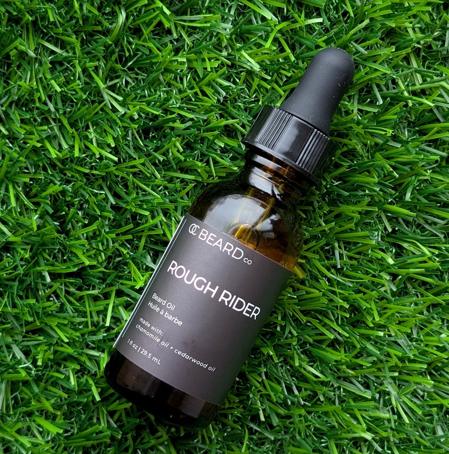 Bottle of 'Rough Rider' beard oil from The Beard Co. on grass