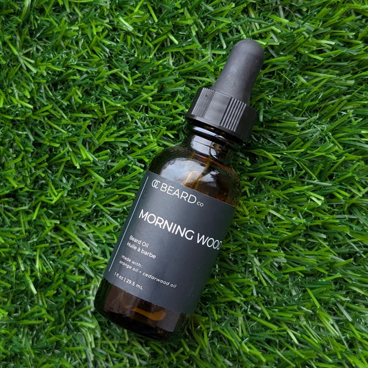 Bottle of 'Morning Wood' beard oil by Beard Co. on grass