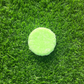 a green Tea Tree + Peppermint Shampoo Bar On gras