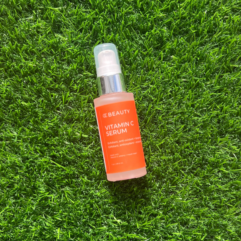 Bottle of vitamin C serum on grass